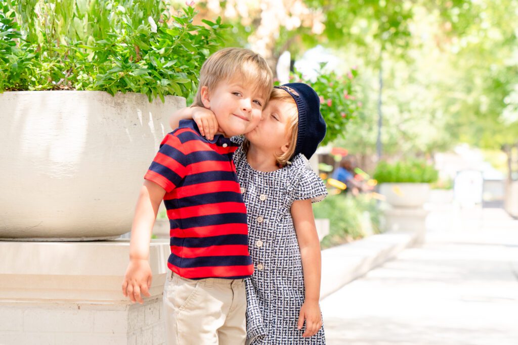 Twin sister hugging her twin brother