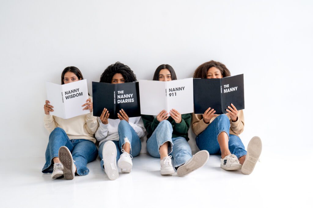 Four nannies sitting down and holding up 4 nanny books about what nannies do